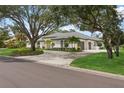 House exterior with mature trees and a large yard at 3973 Boca Pointe Dr, Sarasota, FL 34238