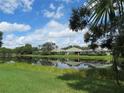 Community lake with houses reflecting in the water at 4939 Lakescene Pl, Sarasota, FL 34243