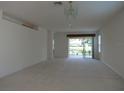 Bright living room with sliding doors to patio and lake view at 4939 Lakescene Pl, Sarasota, FL 34243