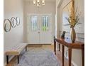 Bright entryway with tiled floor, bench, and decorative mirrors at 5111 51St W Ln, Bradenton, FL 34210