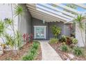 Inviting entryway with a teal front door and nicely landscaped walkway at 305 55Th Nw St, Bradenton, FL 34209