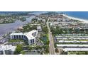 Aerial view of a condo building near beach and waterway at 5855 Midnight Pass Rd # 420, Sarasota, FL 34242