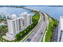Aerial view of condo building near a bridge and water at 128 Golden Gate Pt # 501B, Sarasota, FL 34236