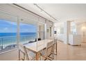 Dining area with ocean view and modern white table and chairs at 603 Longboat Club Rd # 602N, Longboat Key, FL 34228