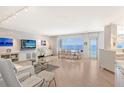 Bright living room with ocean views, hardwood floors, and modern furniture at 603 Longboat Club Rd # 602N, Longboat Key, FL 34228
