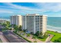 Aerial view of luxurious beachfront condo building with ocean views at 603 Longboat Club Rd # 602N, Longboat Key, FL 34228