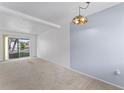 Spacious living room with light-colored walls, carpet, and sliding glass doors to balcony at 2427 Flamingo Blvd # K27, Bradenton, FL 34207