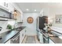 Modern kitchen with stainless steel appliances and dark countertops at 2018 Arden Dr, Sarasota, FL 34232