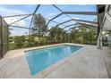 Inviting, refreshing pool with a screened enclosure, perfect for relaxing at 3556 E Forest Lake Dr, Sarasota, FL 34232