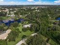 An aerial view of a property that includes a house and a large backyard at 3556 E Forest Lake Dr, Sarasota, FL 34232