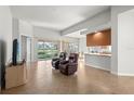 Spacious living room with tile floors, access to the kitchen and backyard at 13180 Ipolita St, Venice, FL 34293