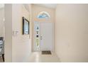 Bright and airy entryway with tile flooring and a mirror at 4995 Pepperwood Pl, Venice, FL 34293