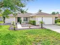 House exterior showcasing a well-maintained lawn and single-car garage at 1410 67Th W St, Bradenton, FL 34209