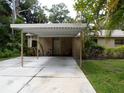 Front view of house with carport and landscaping at 4973 Village Gardens Dr # 50, Sarasota, FL 34234