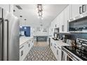 Modern kitchen with white cabinets and stainless steel appliances at 243 Moss Ln, Venice, FL 34293