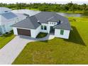 Modern home with dark brown garage door and paver driveway at 1094 Rotonda Cir, Rotonda West, FL 33947