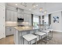 Modern kitchen with gray cabinets, granite countertops, and stainless steel appliances at 4507 Terrazza Ct, Bradenton, FL 34211