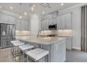 Modern kitchen with gray cabinets, granite countertops, and stainless steel appliances at 4507 Terrazza Ct, Bradenton, FL 34211