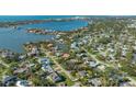 Aerial view showcasing a neighborhood's waterfront location and homes at 1833 Sandalwood Dr, Sarasota, FL 34231