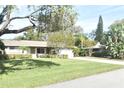 Single story home with a well-maintained lawn and driveway at 1833 Sandalwood Dr, Sarasota, FL 34231