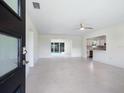 Open concept living room with tile floors, leading to the kitchen and a view of the pool at 104 Alba E St, Venice, FL 34285