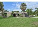 Single story home with a large yard and palm trees at 6106 45Th W St, Bradenton, FL 34210