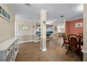 Bright dining room with glass table and wicker chairs at 6503 Mourning Dove Dr # 224, Bradenton, FL 34210