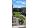 Exterior view of an apartment building with a grassy courtyard and walkways at 400 Base E Ave # 229, Venice, FL 34285