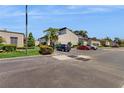 Exterior view of condo building with parking and landscaping at 4409 Sandner Dr, Sarasota, FL 34243