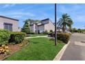 Exterior view of condo building with landscaping and parking area at 4409 Sandner Dr, Sarasota, FL 34243