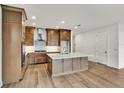 Modern kitchen with an island and hardwood floors at 18876 Daybreak Dr, Venice, FL 34293