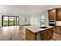 Modern kitchen with island, stainless steel appliances, and hardwood floors at 18876 Daybreak Dr, Venice, FL 34293