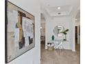 Bright foyer features neutral walls with tile flooring and striking decorative accents at 7390 Divot Loop, Lakewood Ranch, FL 34202
