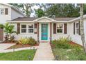 Front door view of a charming home with landscaped walkway and garden at 303 48Th W St, Bradenton, FL 34209