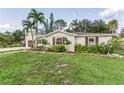 Landscaped yard with a two-story home featuring a modern design at 303 48Th W St, Bradenton, FL 34209