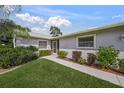 Front view of house with walkway and lush landscaping at 3653 Bonaventure Ct, Sarasota, FL 34243