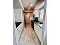 Updated kitchen featuring white shaker cabinets and dark countertops at 1111 Longfellow Rd # 1111, Sarasota, FL 34243