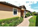 Side yard with walkway leading to the front entrance at 8744 Bellussi Dr, Sarasota, FL 34238