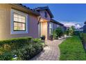 Evening view of home's walkway and landscaped entryway at 8744 Bellussi Dr, Sarasota, FL 34238