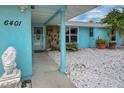 Inviting front entry with a covered walkway and decorative landscaping at 6401 36Th W Ave, Bradenton, FL 34209