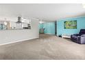 Open concept living and kitchen with carpeted floors and light walls at 6401 36Th W Ave, Bradenton, FL 34209