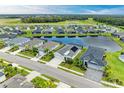 Aerial view of a lakefront community with multiple homes at 12734 Rainwashed Loop, Parrish, FL 34219