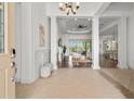 Grand foyer with tile flooring, decorative columns, and an open view into the living room and kitchen at 16729 Collingtree Xing, Bradenton, FL 34202