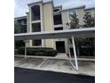 Well-maintained condo building featuring covered parking and well-manicured landscaping at 7005 River Hammock Dr # 404, Bradenton, FL 34212