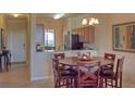 Round dining table with six chairs, kitchen view at 7005 River Hammock Dr # 404, Bradenton, FL 34212