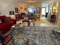 Open-concept living room featuring stylish furnishings, a patterned rug, and a view of the adjacent dining area at 6812 11Th W Ave # 6812, Bradenton, FL 34209