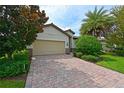Beautiful home exterior with a paved driveway and lush landscaping at 7114 Quiet Creek Dr, Bradenton, FL 34212