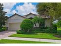 One-story house with a two-car garage and manicured lawn at 7114 Quiet Creek Dr, Bradenton, FL 34212