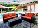 Relaxing patio area with wicker furniture, a coffee table, and a view of the pool at 2244 Palm Ter, Sarasota, FL 34231