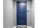 Blue front door with keypad entry and a welcome mat at 383 Aruba Cir # 101, Bradenton, FL 34209